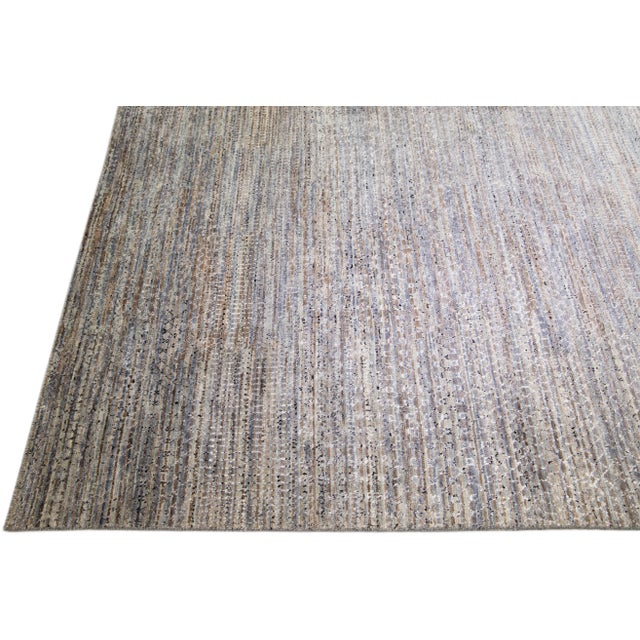 Beautiful contemporary Savannah hand-knotted wool rug with a finely detailed gray color field in an all-over green, brown,...