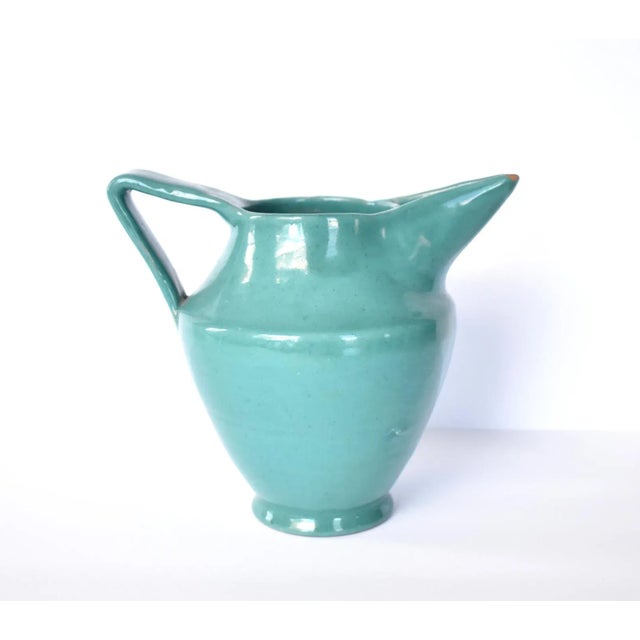 A vintage, mid-century Italian pitcher in a deep jade green with clean, geometric lines. Marked on the bottom, Deruta,...