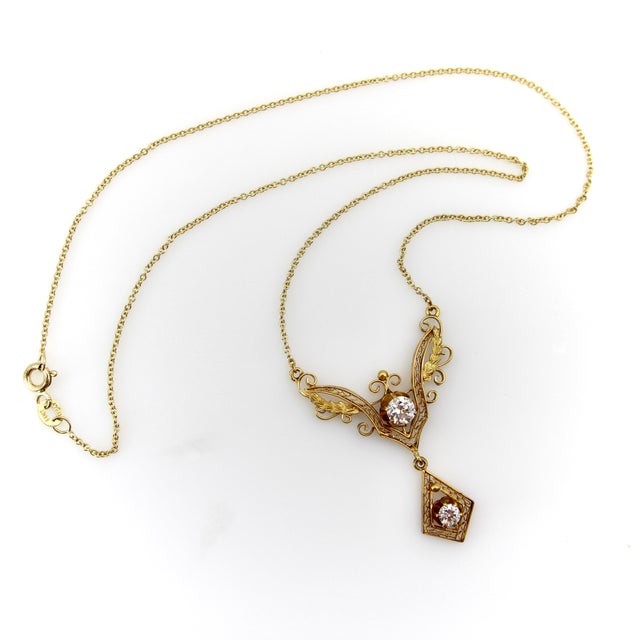 A beautiful Victorian piece with delicate filigree work, this 14k gold pendant is reminiscent of bird wings, as its shape...