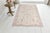 This is a vintage Turkish Oushak rug from the Mid 20th Century. The piece was hand-knotted.