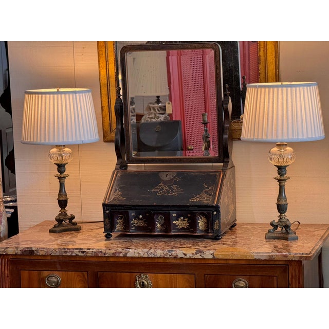Pair of early 19th century French Empire lamps in patinated and gilt metal, each with a faceted cut glass font set in a...