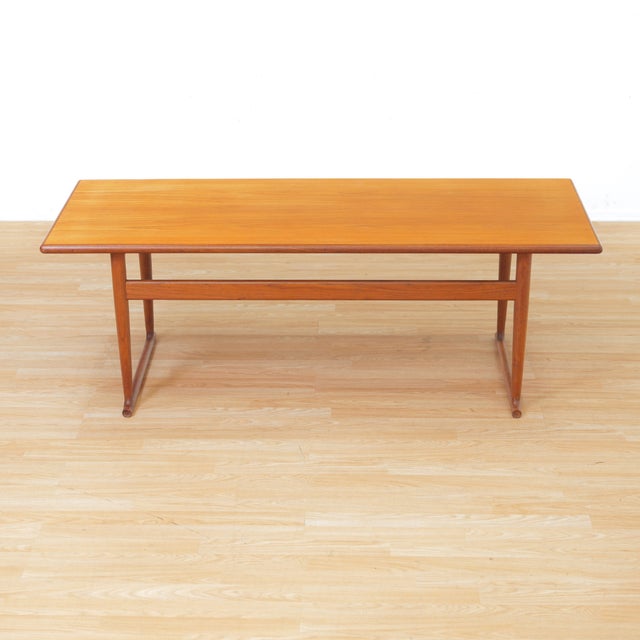 This sleek vintage mid-century coffee table was manufactured in Denmark during the 1970s. Teak construction with a...