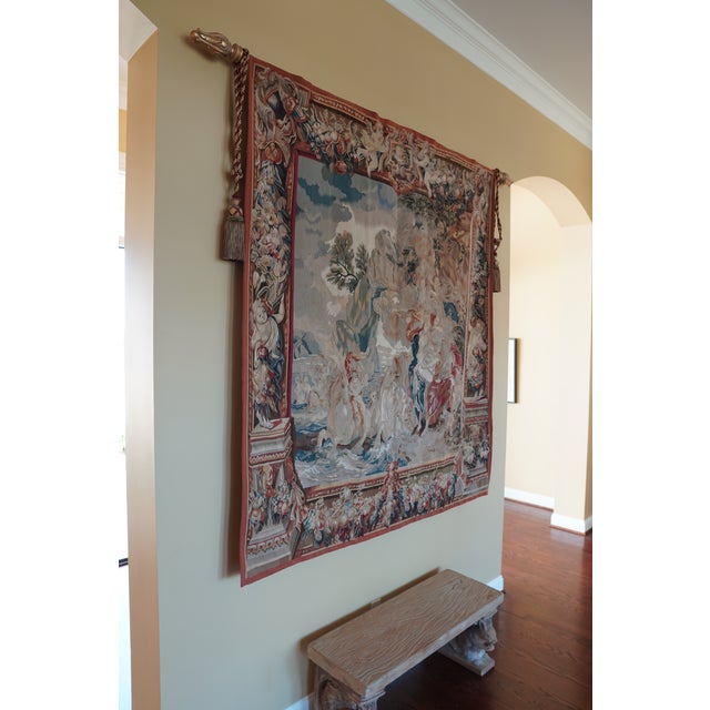 This vintage wall tapestry features a detailed woven scene depicting angels, showcasing traditional textile craftsmanship....