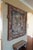 This vintage wall tapestry features a detailed woven scene depicting angels, showcasing traditional textile craftsmanship....