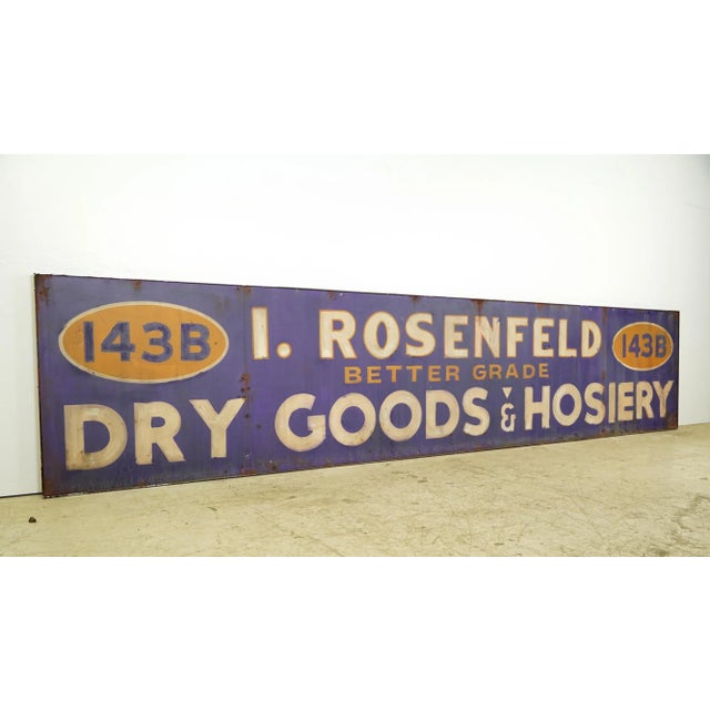 Reclaimed movie set sign made of aluminum in a blue, white, and yellow color. The sign reads "143B, I. Rosenfeld, Better...