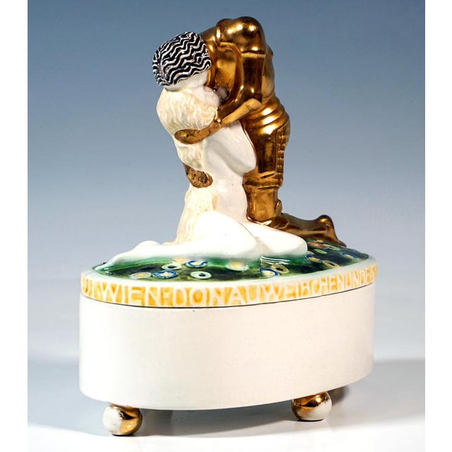 Oval, straight-sided lidded box on four ball feet, with a slightly domed lid featuring a fully sculpted group of figures:...