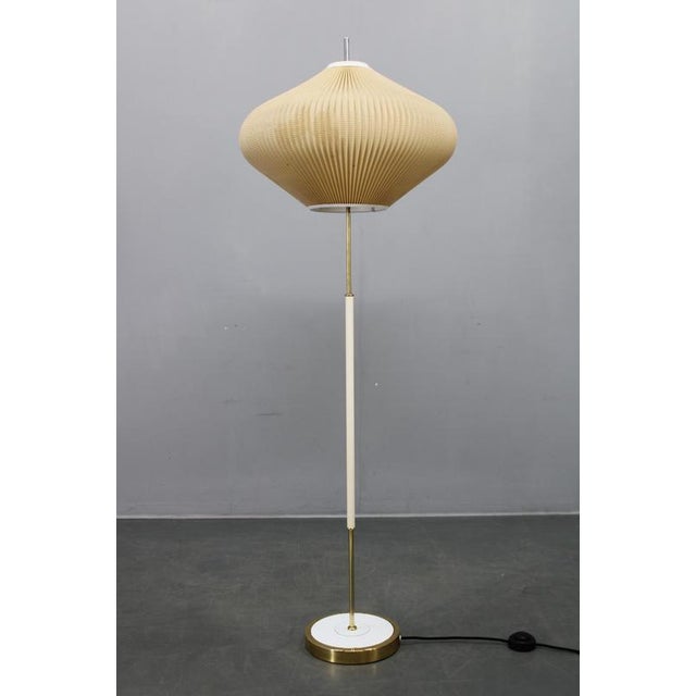 This mid-century modern floor lamp was produced in east germany (gdr) during the 1970s and reflects the understated...