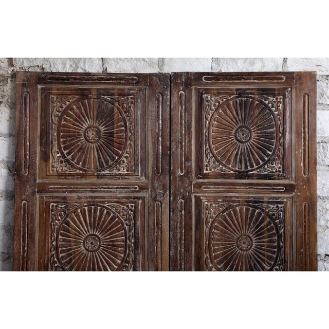 This antique hand-carved door features a mesmerizing floral chakra design, symbolizing balance and harmony. Crafted from...
