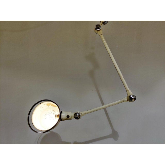 Charming Industrial articulated wall or desk lamp salvaged from a hospital. This Industrial lamp has 3 articulated joints...