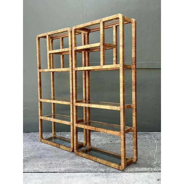 This exceptional pair of vintage wrapped rattan etageres perfectly captures the breezy sophistication of 1970s Hollywood...