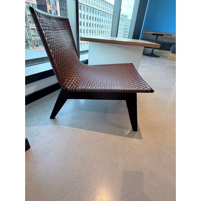 Woven leather chair designed by Mermelada Estudio for CB2. Construction: Acacia wood frame, brown leather woven seat