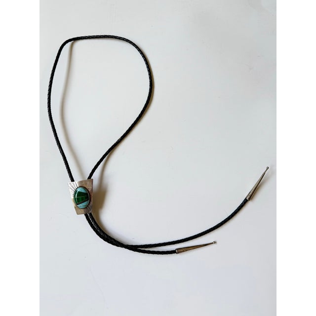Beautiful multi-stone inlaid bolo tie with vintage Bennett-style tension clamp. Stamped silver end caps. Masterfully...