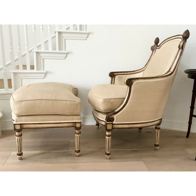 ***Needs new upholstery*** French style bergère with carved wooden frame, fluted legs and finial accents. The matching...