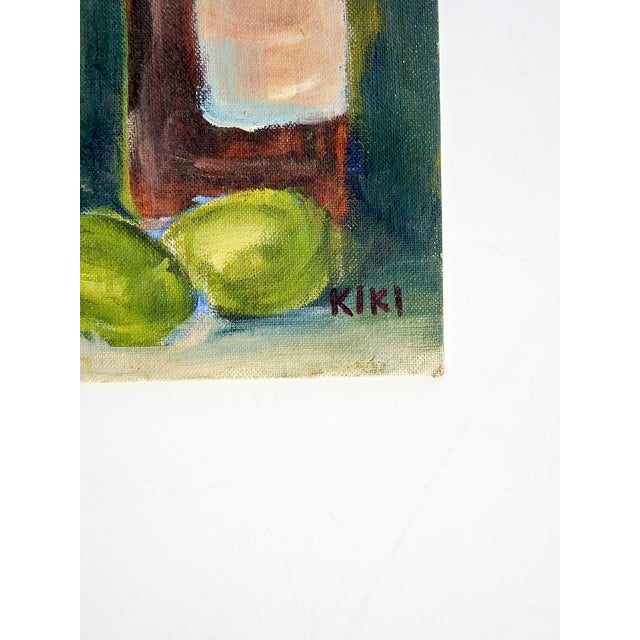 Late 20th century oil on canvas board still life with bottle of wine, limes and white daisies in a tuquoise vase. Signed...