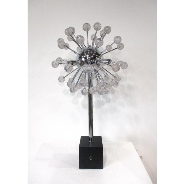 A very unique Space Age chrome and Lucite table lamp with over 40 jetting Lucite balls with bubbles inside giving it the...