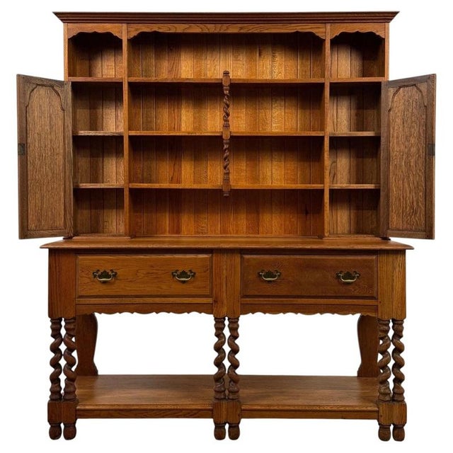 An impressive early 20th-century English dresser, finely crafted from golden oak and distinguished by its extensive...