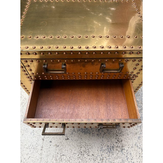 Campaign style nightstand made from wood covered in brass. Solid brass handles and studs provide a touch of glam. Perfect...