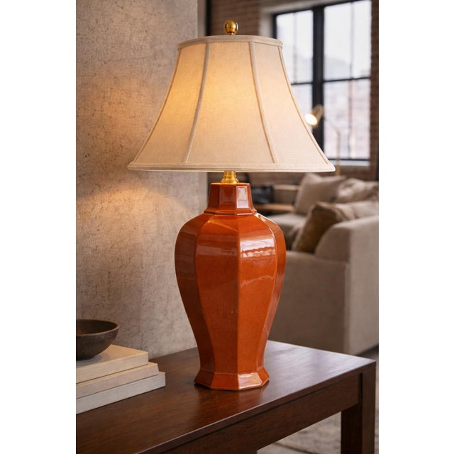 A bold, sculptural late 20th century ceramic table lamp featuring a faceted architectural urn form in high-gloss...