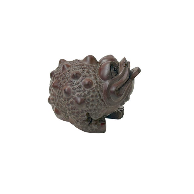 This carved wooden figurine depicts a Jin Chan, or the "Money Toad," a popular Feng Shui charm for prosperity. Crafted...