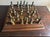 Decorative Mid 20th Century chess set with handcrafted cast metal chess pieces in Medieval style and a wooden chess board....