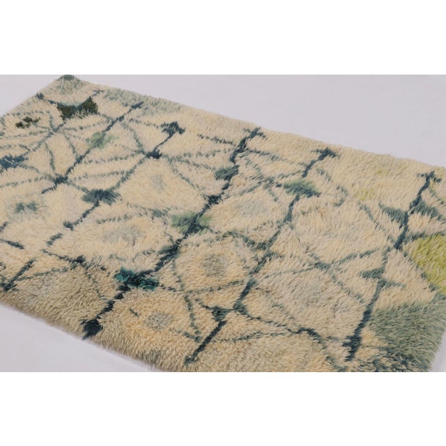 Hand-knotted in lush, high-pile wool in Sweden circa 1960-1970, this 4x6 vintage Swedish Rya rug is a bold new addition to...