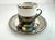 A refined vintage demitasse service featuring six porcelain cups with sleek silver rims, each nestled into sculptural...