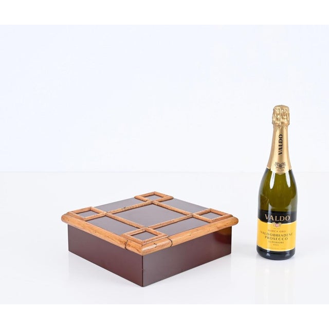 Stunning large midcentury decorative box in a dark red bakelite and bamboo. This lovely piece was designed by Tommaso...