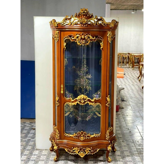 Elevate your home with the grandeur of this magnificent French Louis XV display cabinet, an extraordinary statement piece...