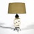 This playful table lamp has several qualities of 1950s design: the ceramic body has an urn-like form, is decorated with a...