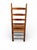 Charming antique ladderback chair featuring beautifully turned wood spindles, classic arched slats, and a handwoven rush...