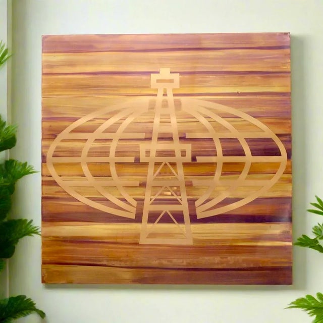 Large copper & brass plate acid etched with mid century era image of oil rig positioned prominently before a grid globe...