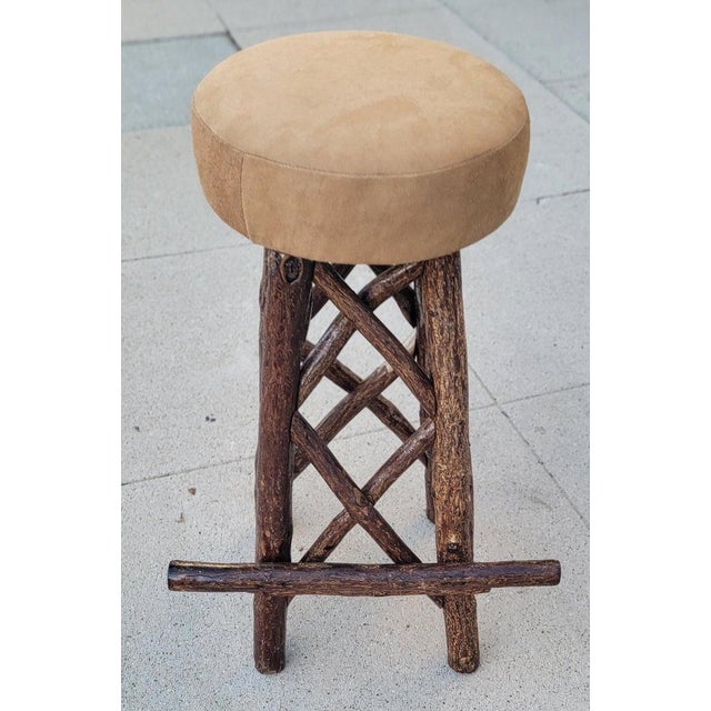 Collection of four, hand-made hickory stools with leather seat and soft inserts. In very sturdy condition. We have a...