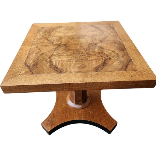 An elegant vintage side table by Baker Furniture featuring a highly figured book-matched walnut top and sculptural...