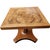 An elegant vintage side table by Baker Furniture featuring a highly figured book-matched walnut top and sculptural...