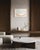 A soft, opalescent oval rests on warm taupe, its lower curve traced in a thin band of gold leaf that catches the light...