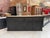 This antique sideboard made of solid cherry wood has been completely restored. It features a natural wood top and a black-...