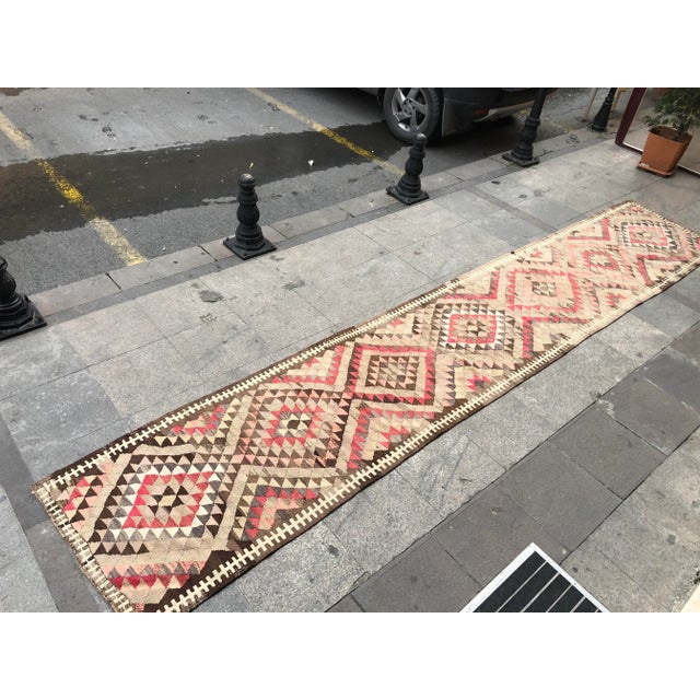 This is a vintage Turkish Oushak rug from the 1960s. The piece was hand-knotted.