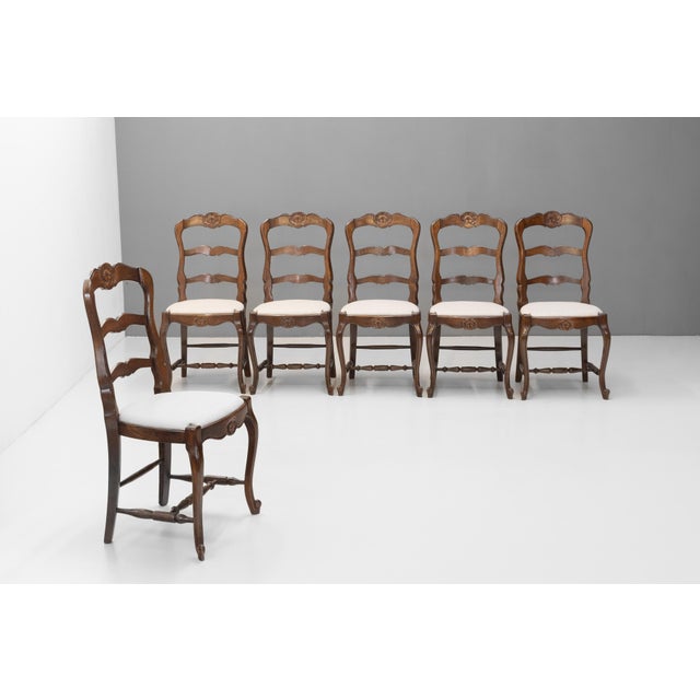 Set of six oak dining chairs newly polished with reupholstered linen seats. Circa 1930.