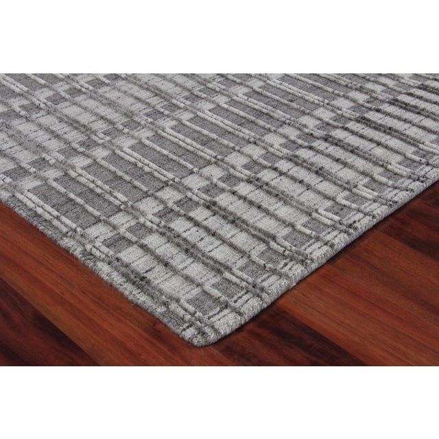 A unique take on the classic striped rug. The interesting textured geometric design, and tone-on-tone palette of the...