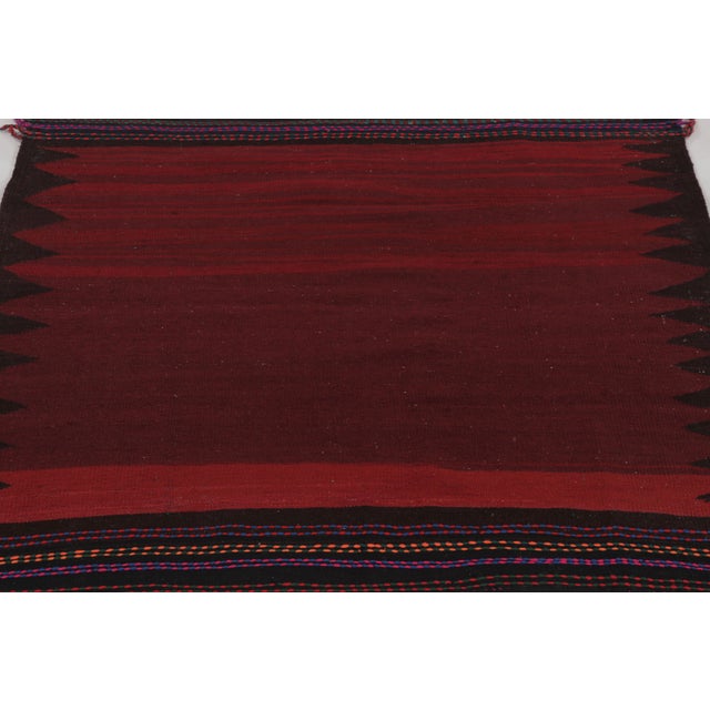 Made with handwoven wool circa 1950-1960, this 4x4 vintage square flat-weave Sofreh Kilim is a particularly dramatic and...