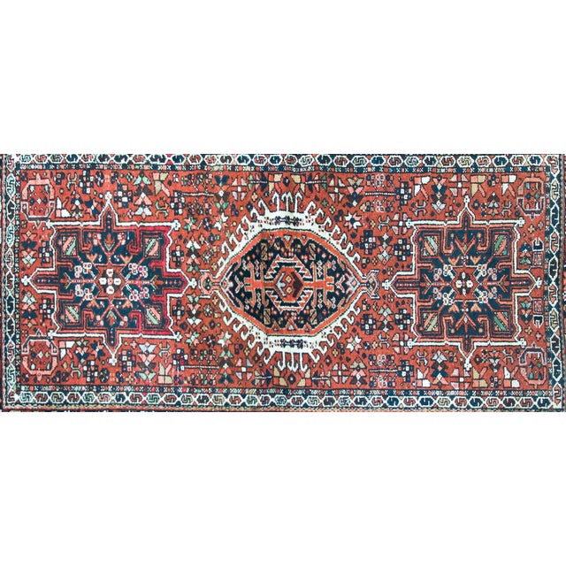 A striking early 20th century Persian Karaja rug with a tribal pattern containing three large central medallions heavily...