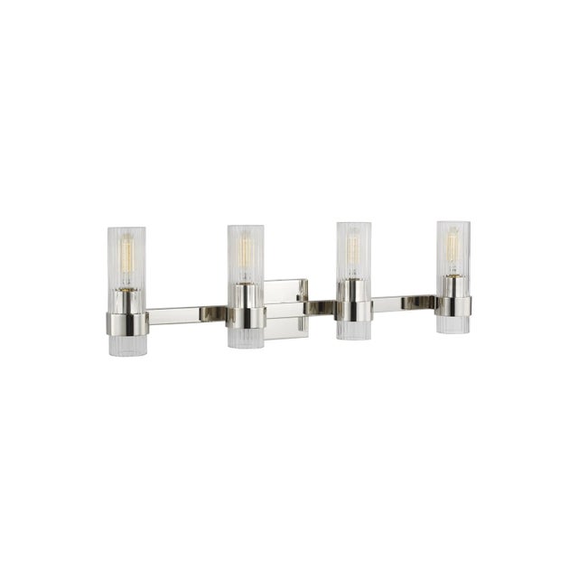 In the Geneva four light vanity fixture, slender, fluted shades form an elegant, dynamic silhouette that's balanced by a...