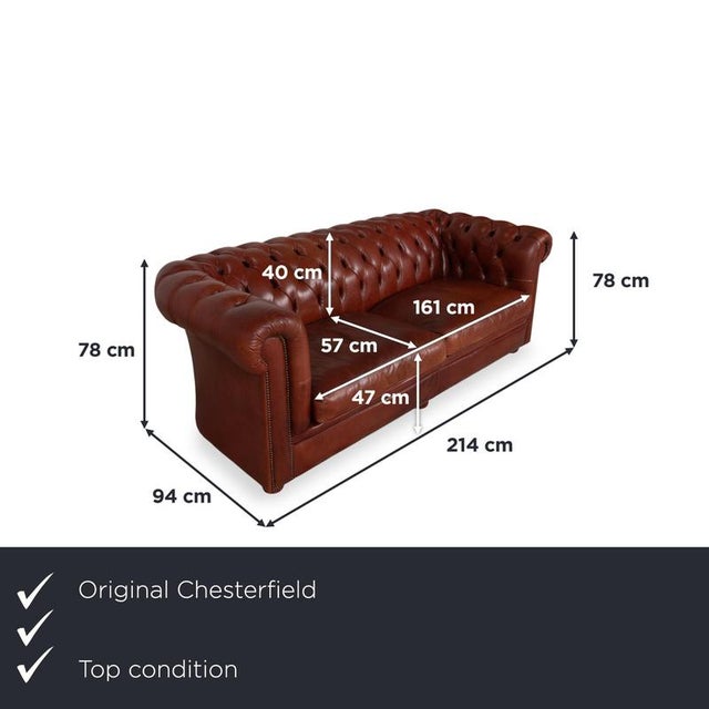 Bring the epitome of British seating tradition into your living room with this Chesterfield three-seater sofa. The dark...
