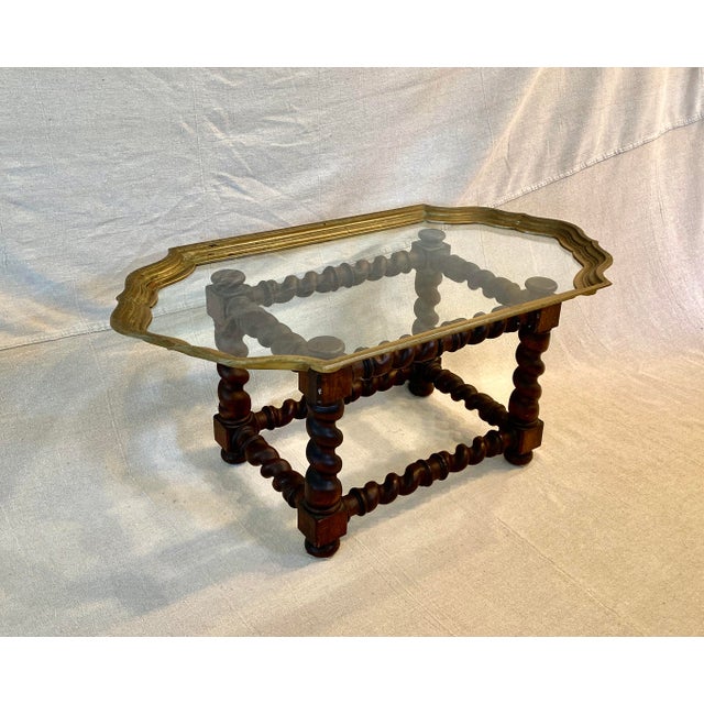 This amazing substantial barley twist oak table base is complimented by a scalloped brass framed glass tray top. While...