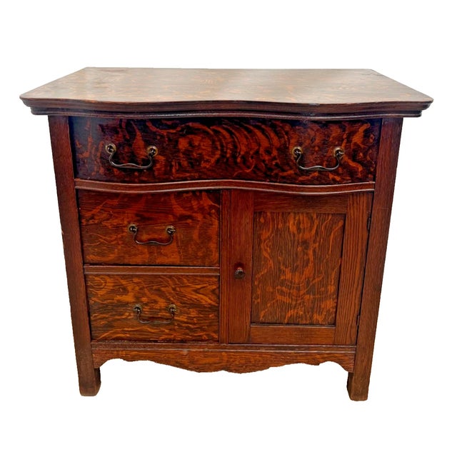 Exceptionally figured late 19th-century Victorian single-door cabinet and three drawer commode. Crafted from richly...