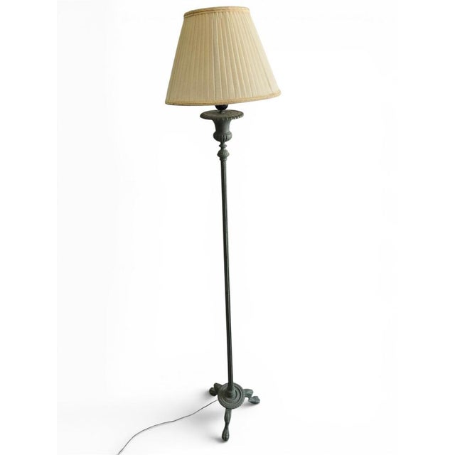An impressive Romanesque Revival floor lamp dating from the 1950s, crafted from solid bronze and finished with a rich...
