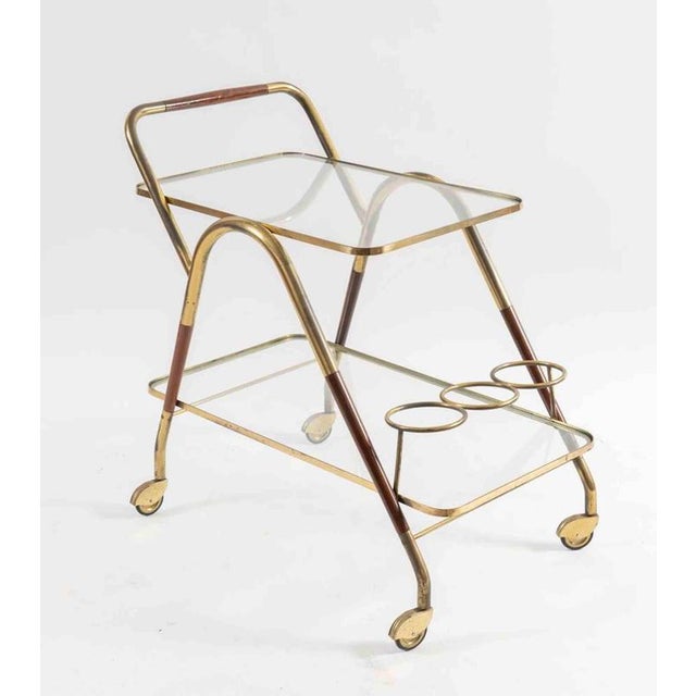 Bottle trolley with brass structure, briar details and glass shelves. Made in Italy, around 1960s. 70 x 50 x 74 cm. Good...