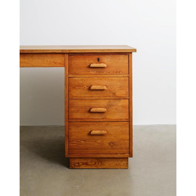 A very rare and most likely unique swedish mid century modern wooden desk model "värmdö" in solid stained pine with five...