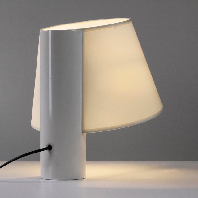 Italian-made lamp from the 1960s, consisting of a cylindrical body in white lacquered metal and a truncated cone-shaped...