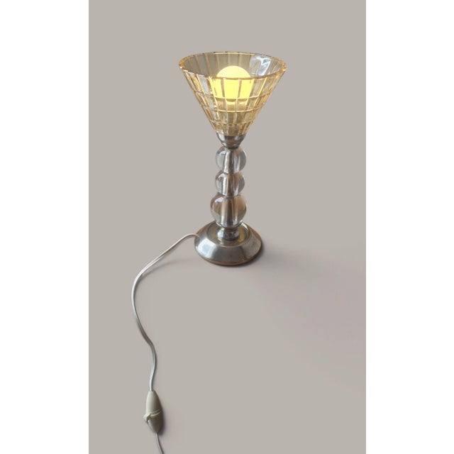Modernist design lamp with mid-20th-century influences (1950s-1960s) attributed to Jacques Adnet. • Chrome-plated metal...